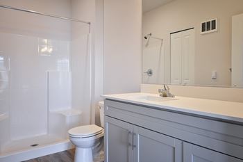 a bathroom with a toilet sink and shower